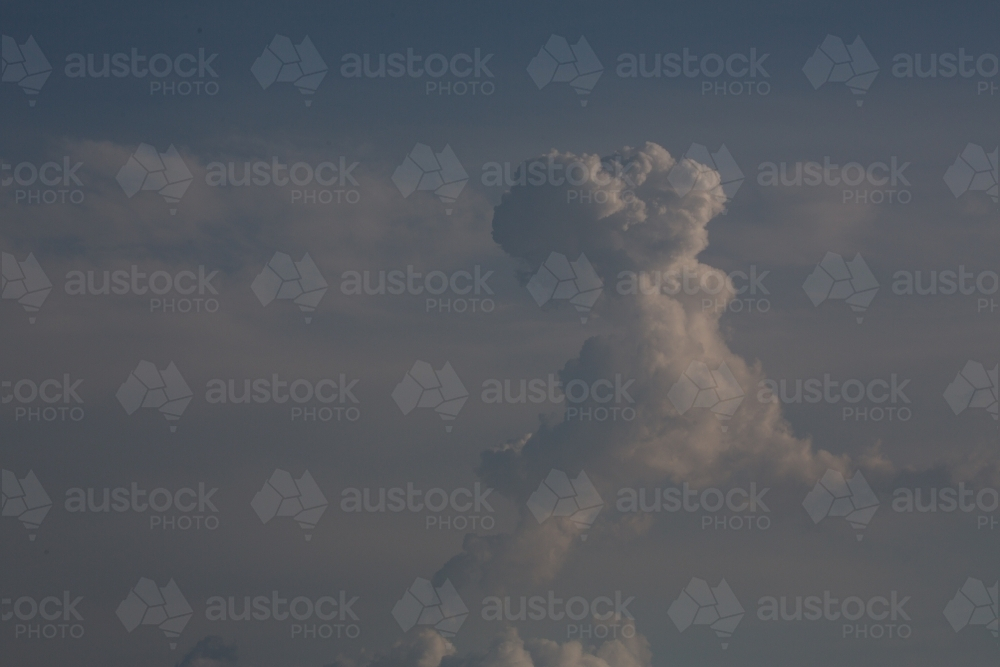 A large, towering cloud formation against a blue sky. - Australian Stock Image