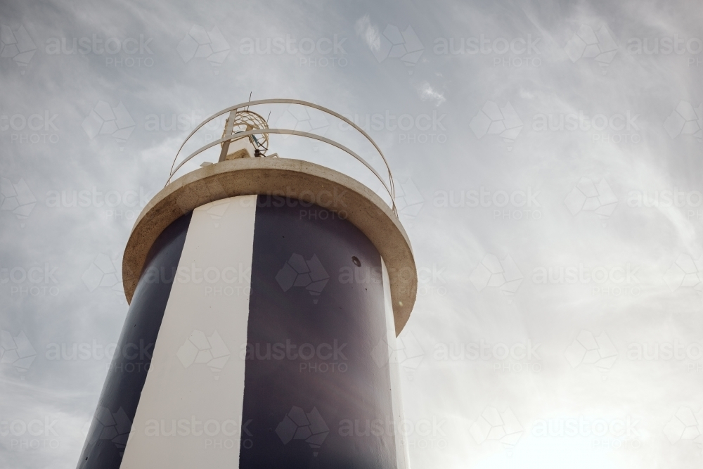 A lighthouse with a cylindrical shape under the clear sky. - Australian Stock Image