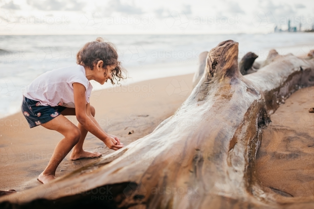 A little girl playing at the beach - Australian Stock Image