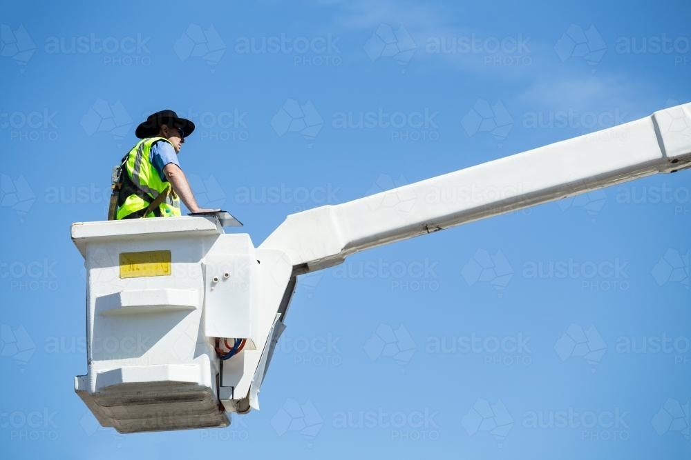 A man in a cherry picker - Australian Stock Image