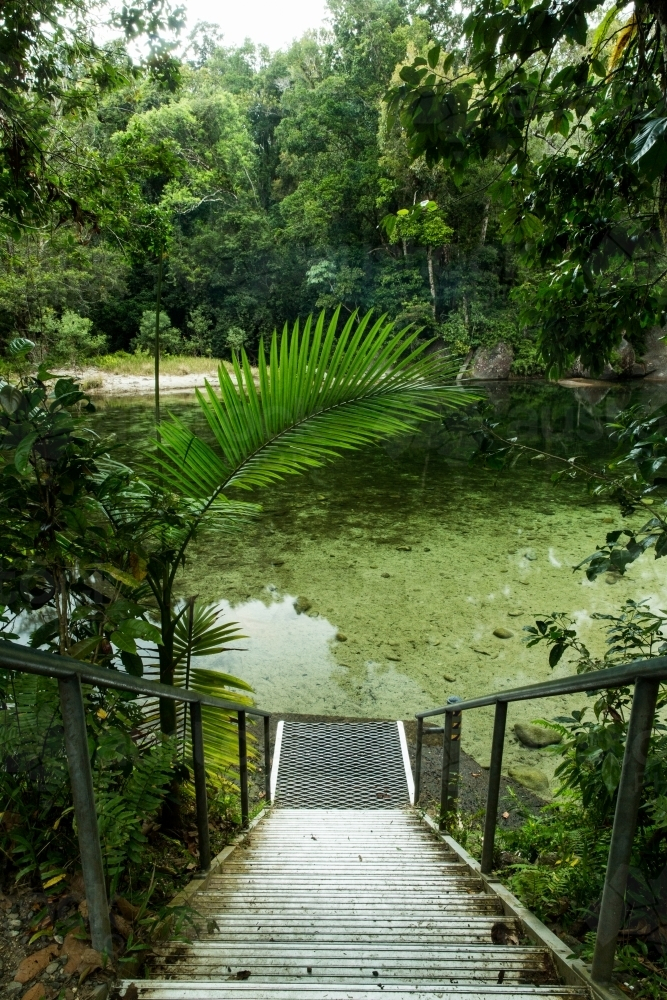 A metal staircase leading down to the water. - Australian Stock Image