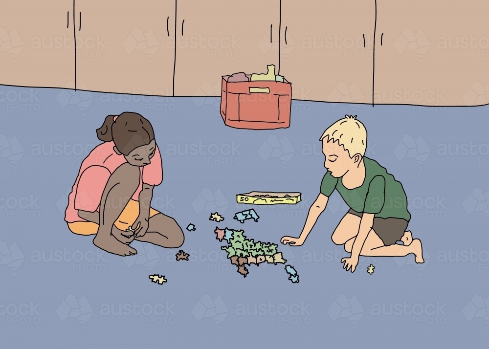 A mixed ethnicity girl and a Caucasian boy doing jigsaw puzzle together on floor - Australian Stock Image