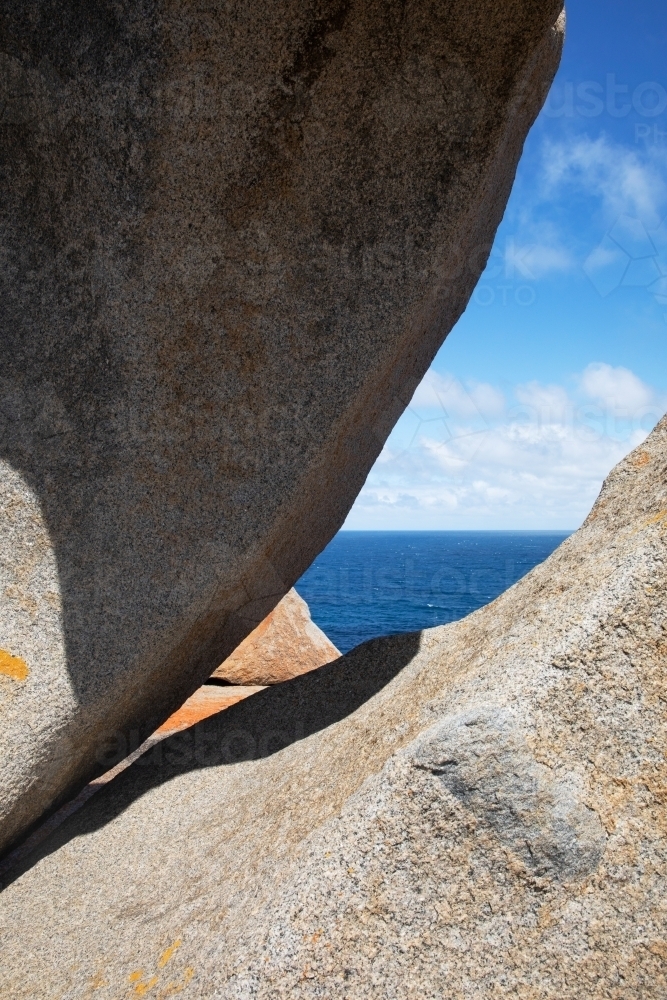 A natural window formed by two large smooth boulders - Australian Stock Image