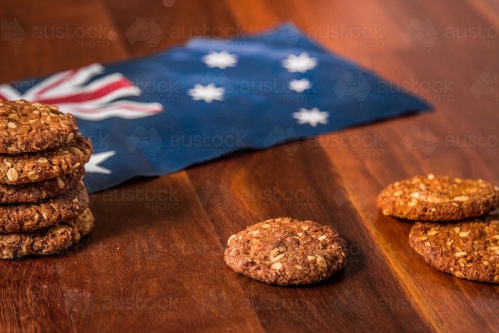 A pile of ANZAC biscuits next to the Australian flag - Australian Stock Image