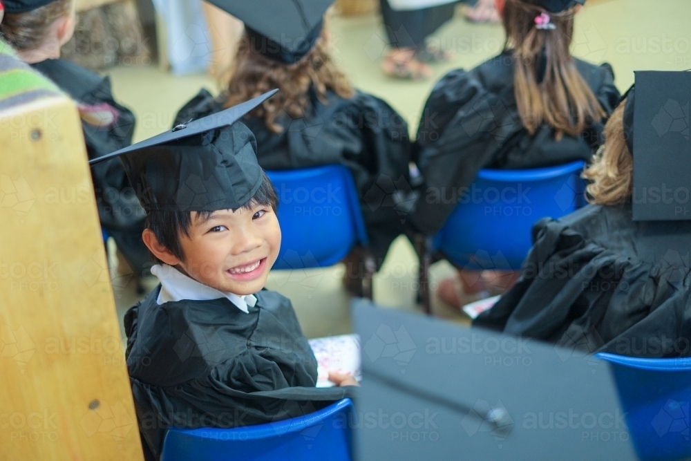 a proud kid on his pre-school graduation day - Australian Stock Image