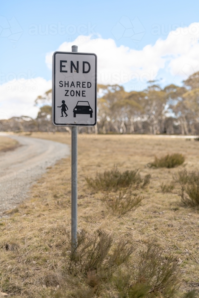 A road sign in a rural setting indicating that the road is shared between cars and pedestrians - Australian Stock Image