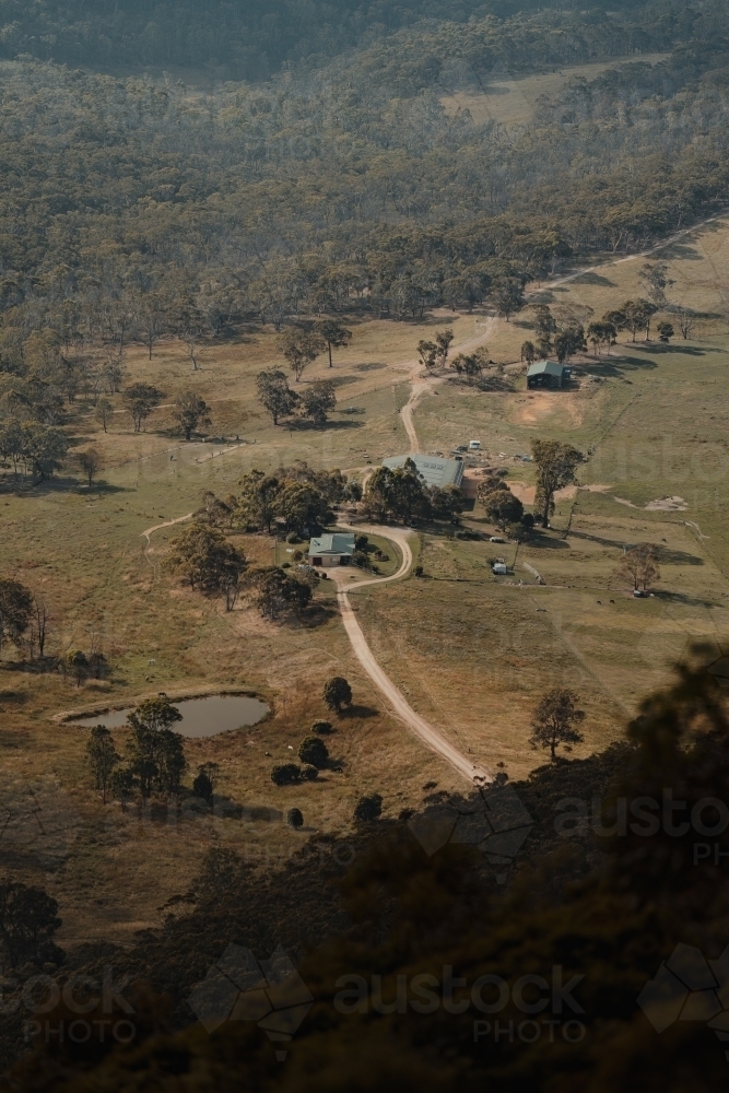 A rural homestead in the valley surrounded by mountains as seen from Blackheath Lookout - Australian Stock Image