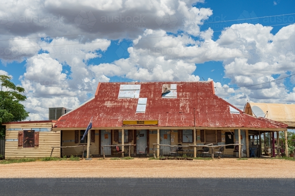 A rustic outback pub with a red tin roof and wide veranda - Australian Stock Image