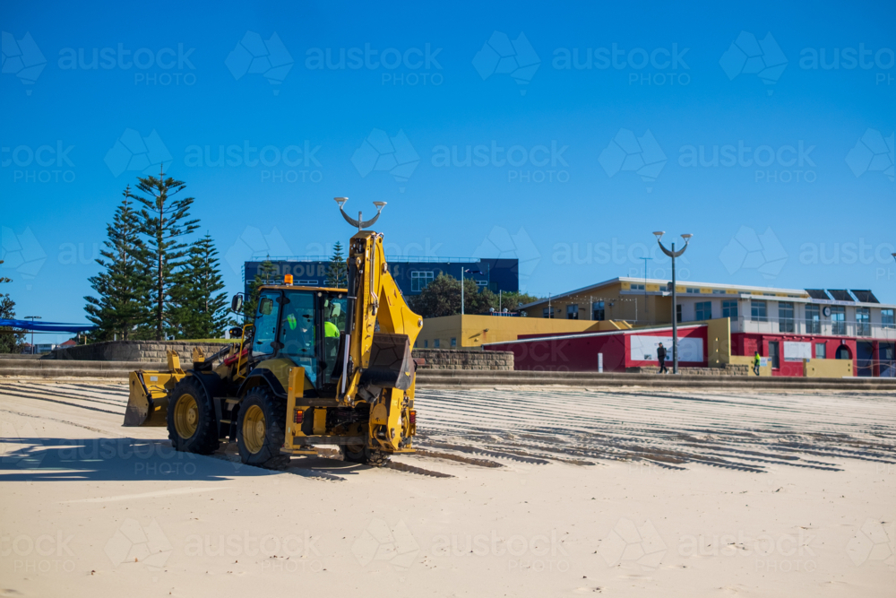 A sand digger truck plowing the beach at Maroubra - Australian Stock Image