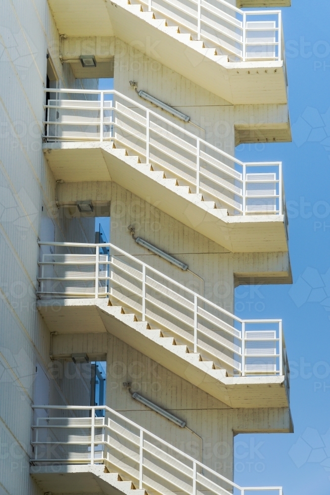 A series of exterior staircases leading up the side of a building - Australian Stock Image