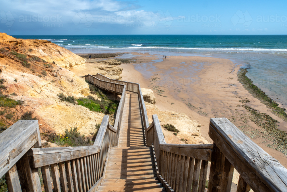 A set of wooden steps with railings descending to a beach at Onkaparinga River Mouth - Australian Stock Image