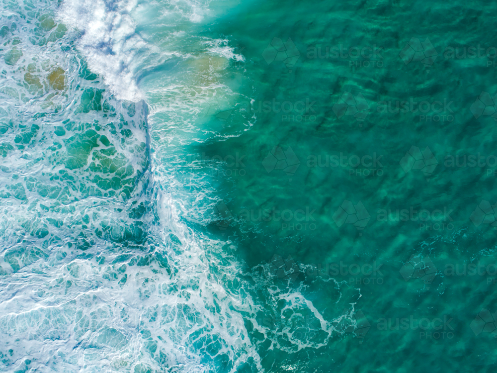 A small wave begins to crash on a shallow reef - Australian Stock Image