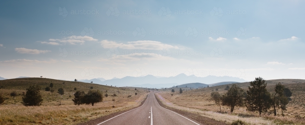 A straight sealed road leading to the Flinders Ranges - Australian Stock Image