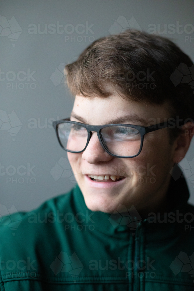 A teenage boy with black glasses smiling - Australian Stock Image