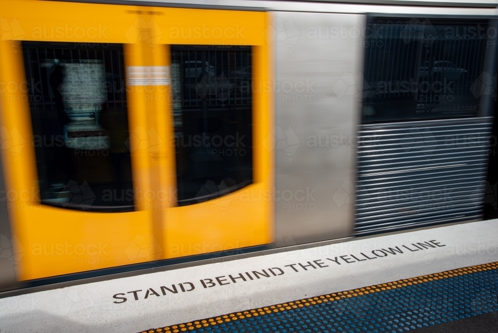 A train moving along the platform - Australian Stock Image