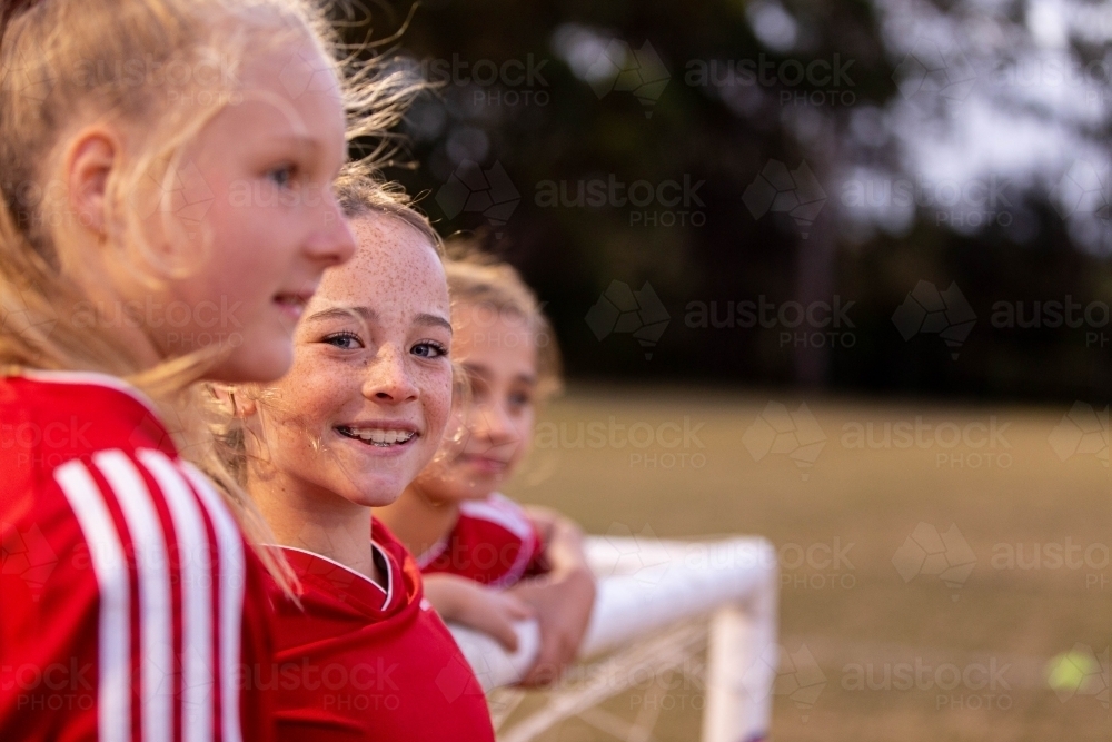 Image of A tween girls football team training together at a sports oval ...