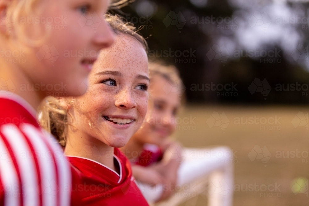 Image of A tween girls football team training together at a sports oval ...