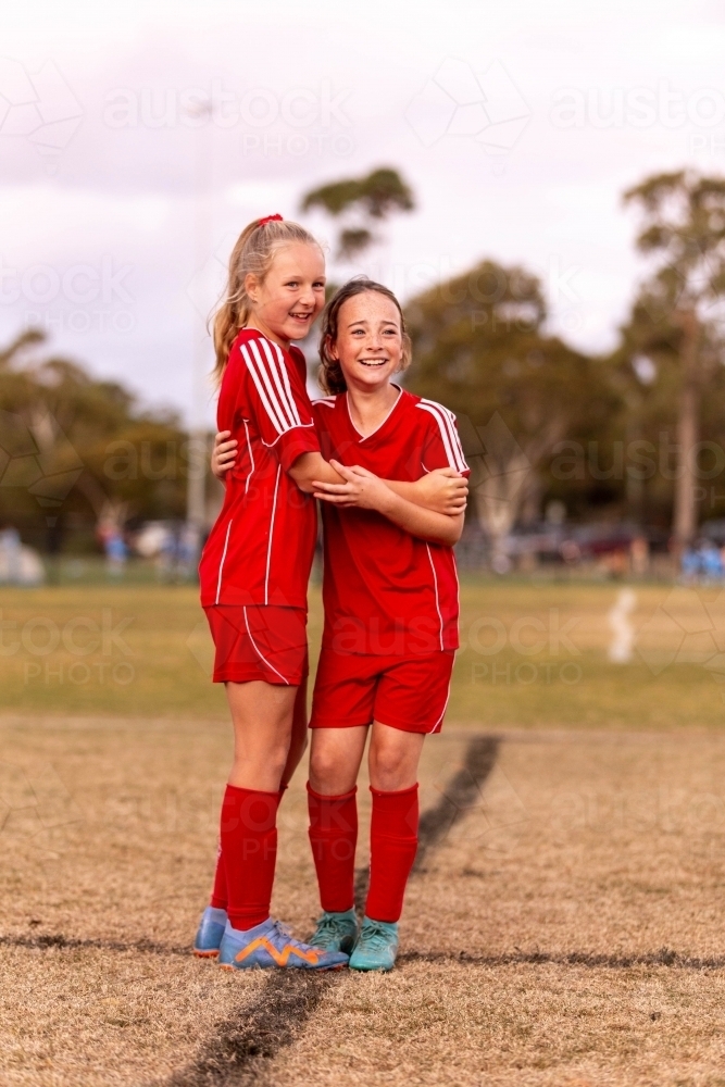 Image of A tween girls football team training together at a sports oval ...