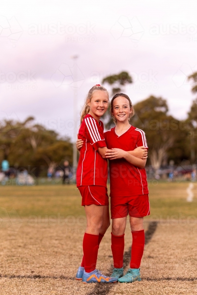 Image of A tween girls football team training together at a sports oval ...