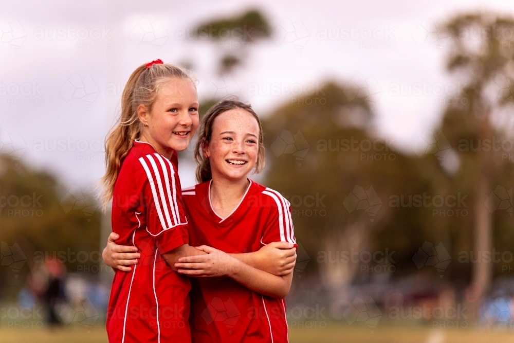 Image of A tween girls football team training together at a sports oval ...