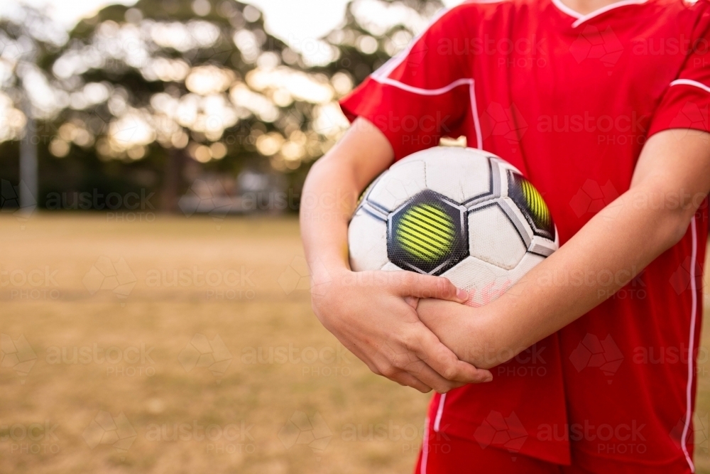 A tween girls football team training together at a sports oval - Australian Stock Image