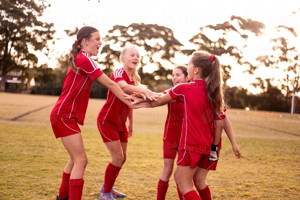 A tween girls football team undertaking team bonding and motivation - Australian Stock Image