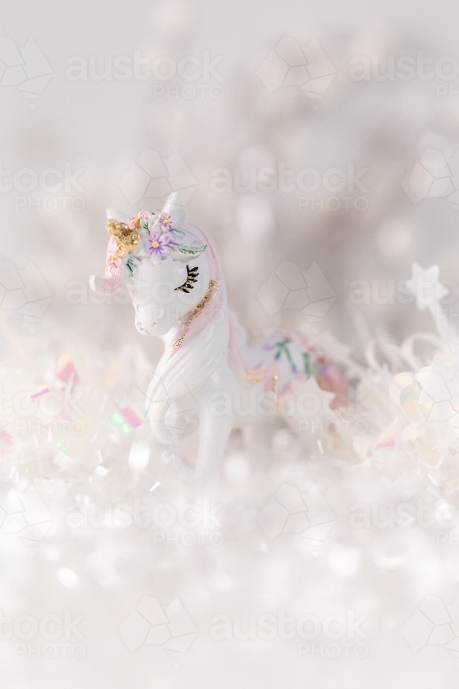 A unicorn figurine with a whimsical background. - Australian Stock Image