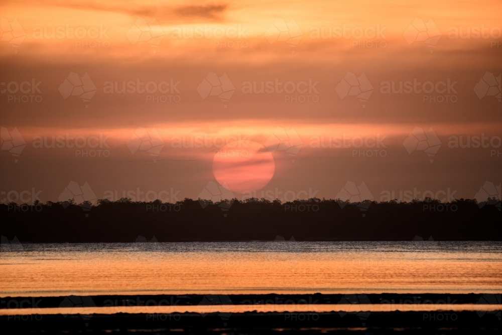 A warm sunset glow over the lake. - Australian Stock Image