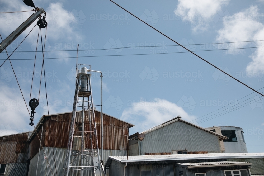 A water tower with old and rusted metal corrugated metal in Old Whaling Station - Australian Stock Image