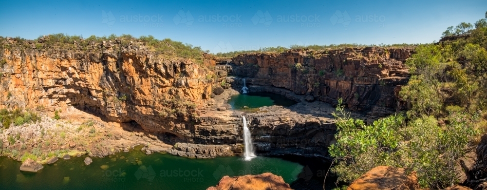 A waterfall cascades down from a rocky cliff. - Australian Stock Image