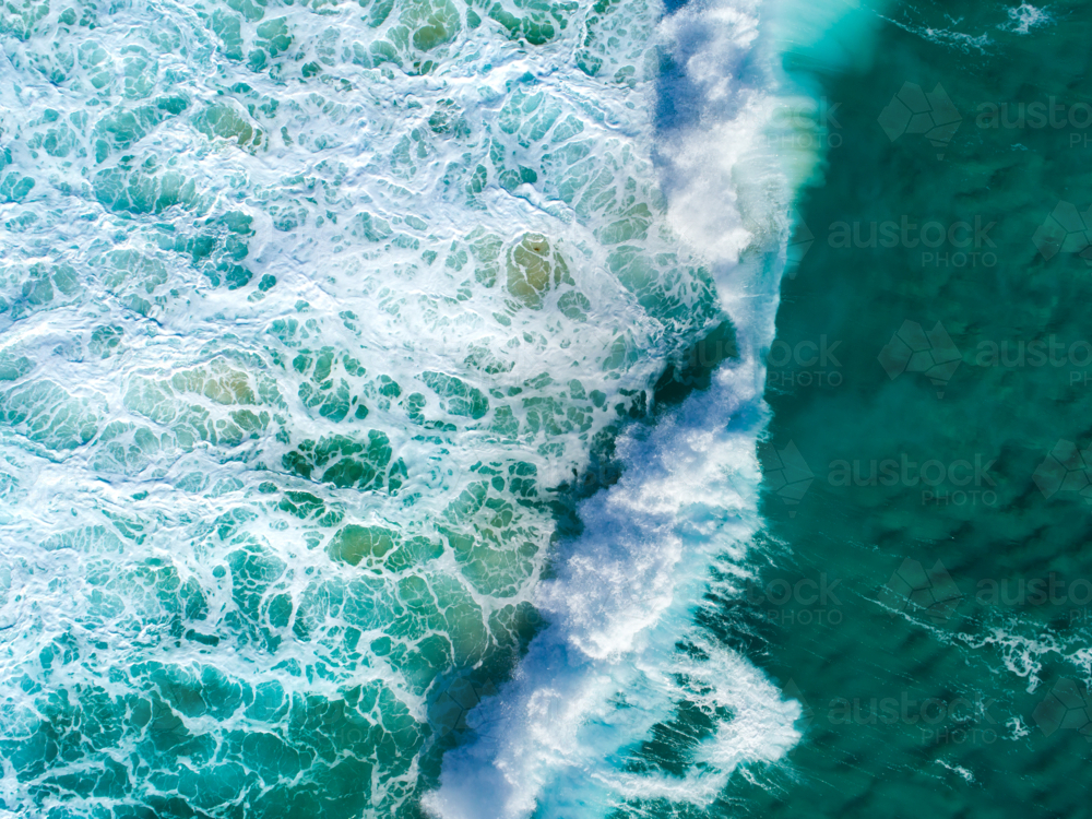 A wave collapses over a shallow reef in the ocean - Australian Stock Image