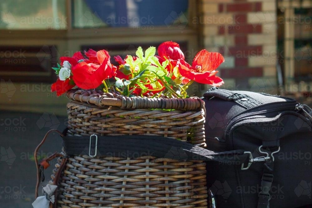 A wicker basket of red poppies - Australian Stock Image