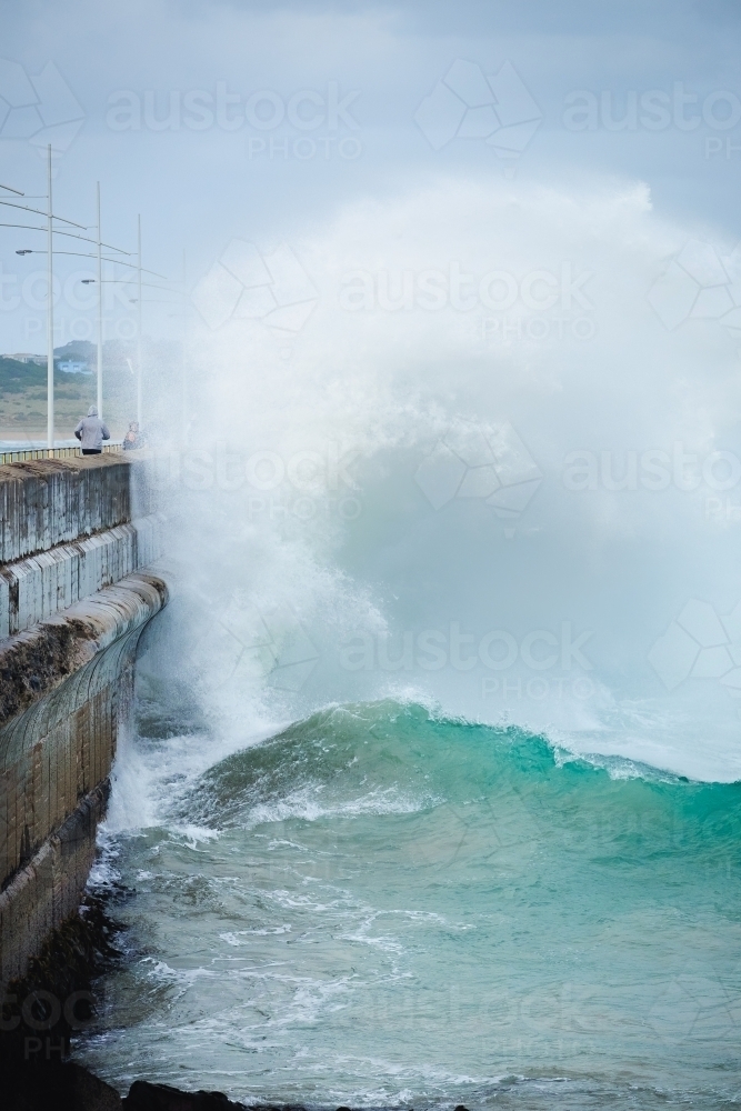 A wild wave crashes against the breakwall - Australian Stock Image