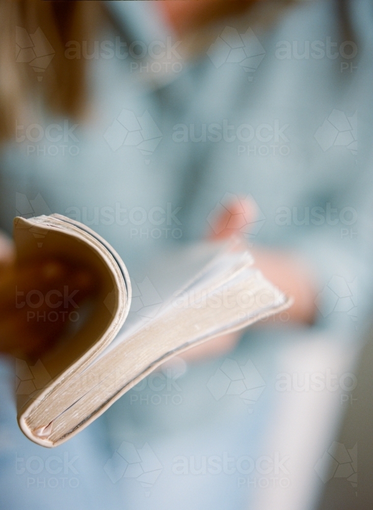 A woman opening a bible book to read - Australian Stock Image