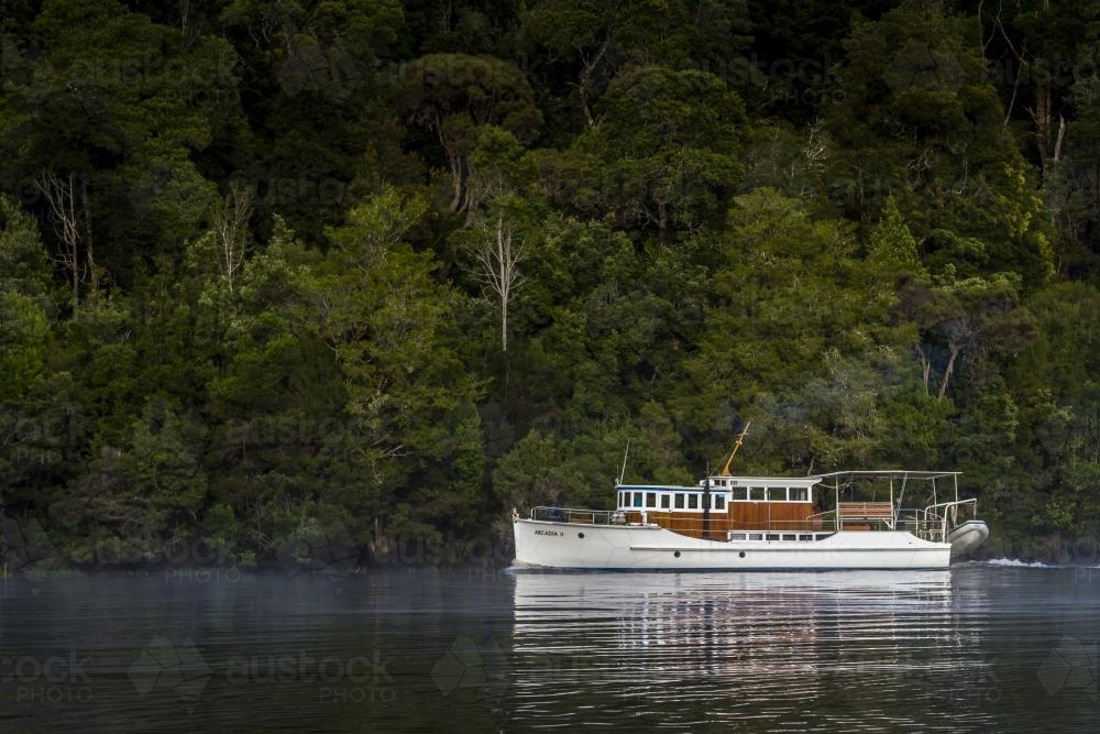 A wooden boat on the Pieman River. - Australian Stock Image