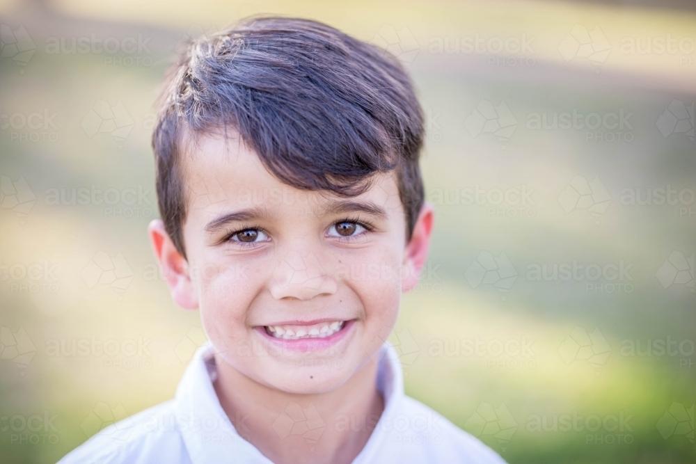 Aboriginal and caucasian mixed race boy smiling - Australian Stock Image