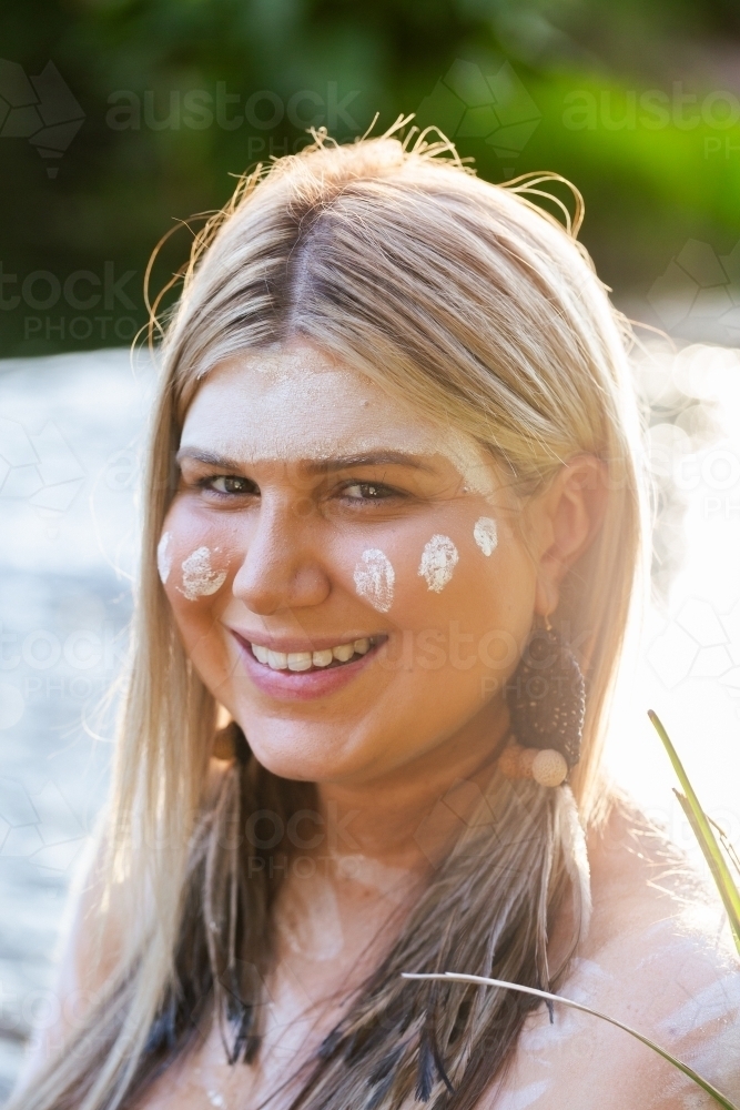 Aboriginal Australian woman on country in traditional dreamtime ochre body paint - Australian Stock Image