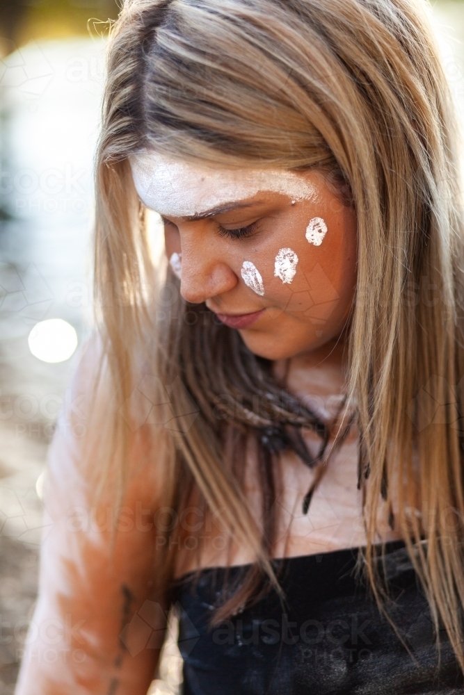 Aboriginal Australian woman with white ochre paint on face - Australian Stock Image