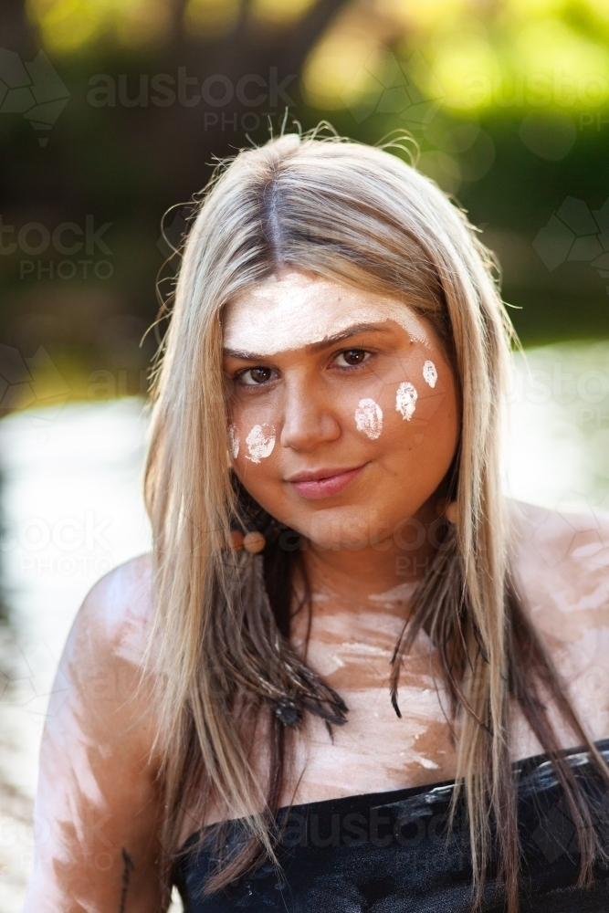 Aboriginal Australian woman with white ochre paint on skin - Australian Stock Image