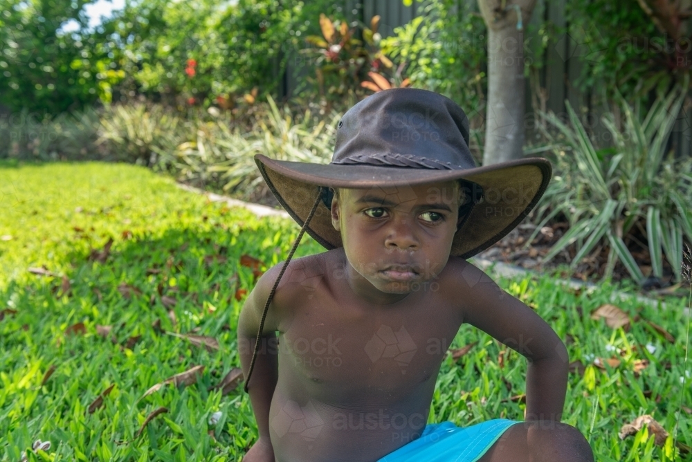 Aboriginal child wearing hat - Australian Stock Image