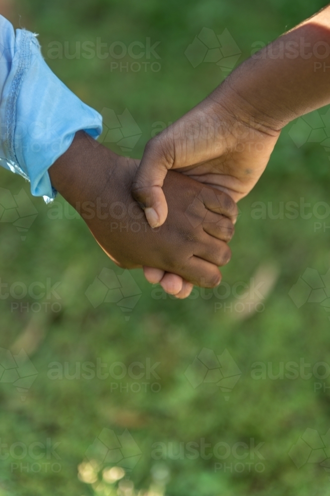 Aboriginal children holding hands - Australian Stock Image