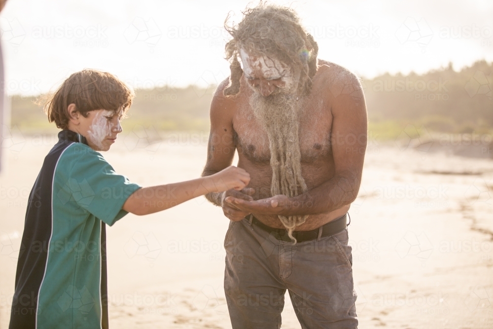 image-of-aboriginal-father-helping-son-on-a-beach-austockphoto