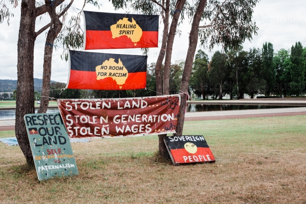 Aboriginal flags with rights signs in trees - Australian Stock Image