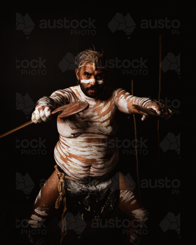 Aboriginal male holding boomerangs - Australian Stock Image