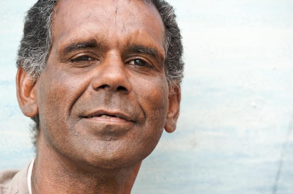 Aboriginal Man Looking at Camera with a Half Smile - Australian Stock Image