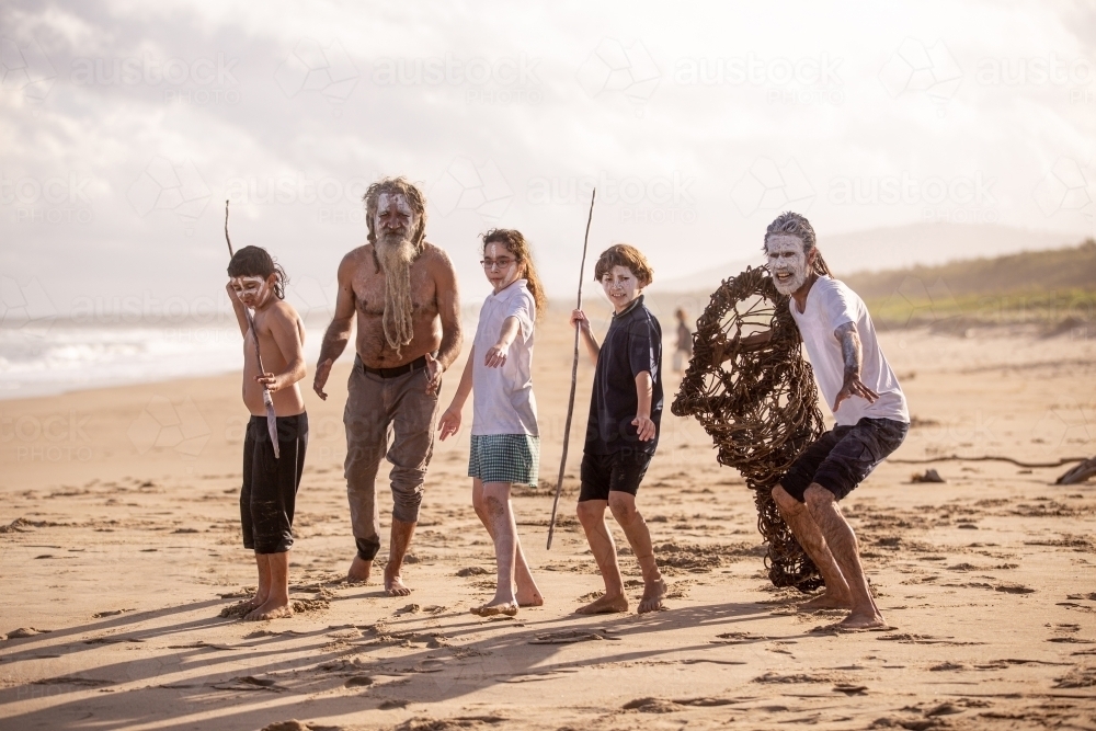 Aboriginal mob at the beach looking at camera elders with next generation - Australian Stock Image