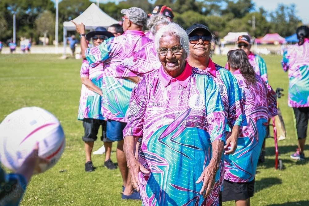 Aboriginal team passing netball - Australian Stock Image