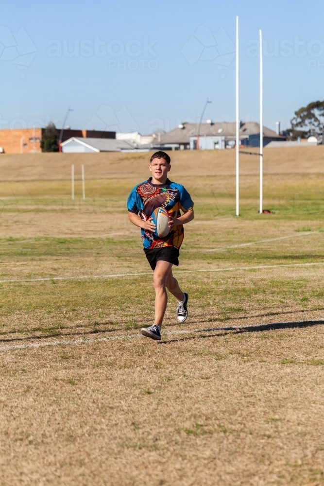 Aboriginal teen playing sports - Australian Stock Image