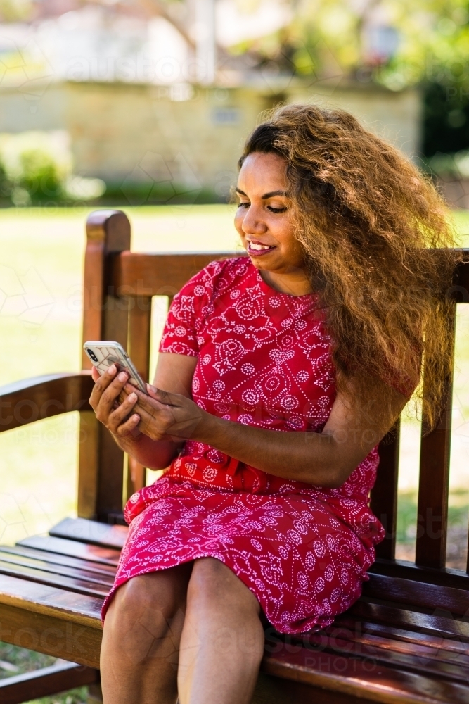 aboriginal woman using mobile phone - Australian Stock Image