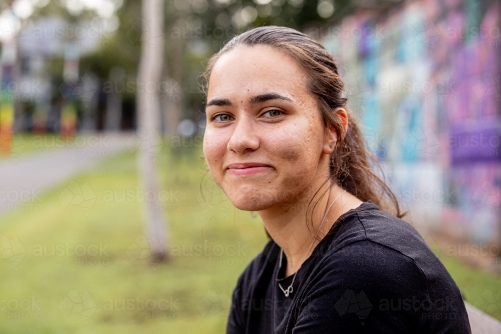 Aboriginal woman with dimple smiling in a park - Australian Stock Image